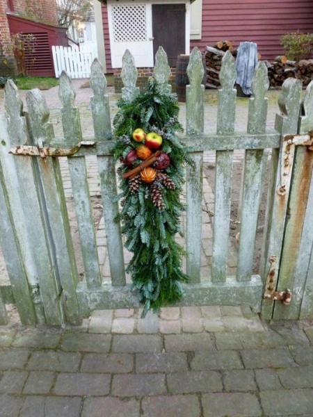 Christmas swag on gate with fruit pinecones and cinnamon sticks